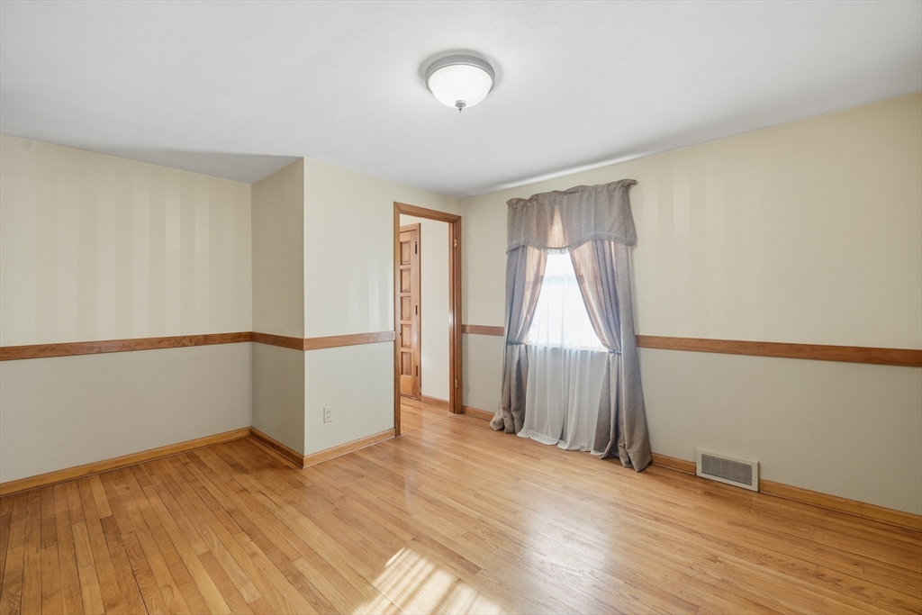 80 Jean Drive Springfield, MA 01104 - Photo 20 of 42 a view of an empty room with wooden floor and a window