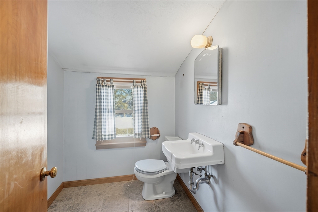 80 Jean Drive Springfield, MA 01104 - Photo 30 of 42 a bathroom with a sink a toilet and a window