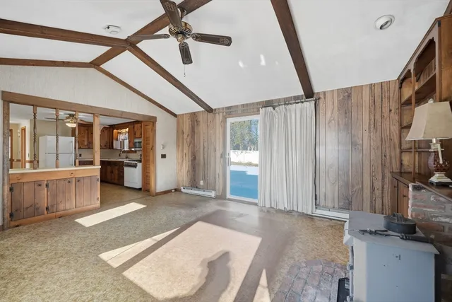 a view of an empty room with cabinet and mirrors