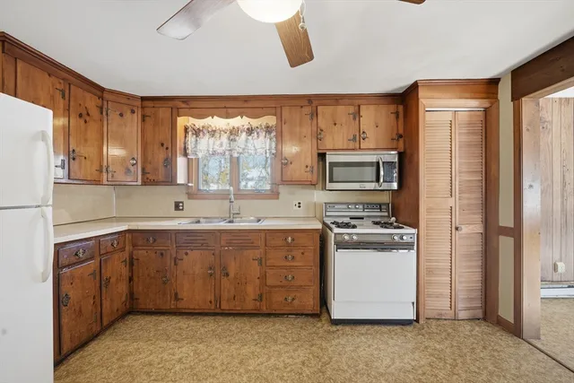 a kitchen with stainless steel appliances a refrigerator a stove a sink dishwasher and a oven with wooden floor