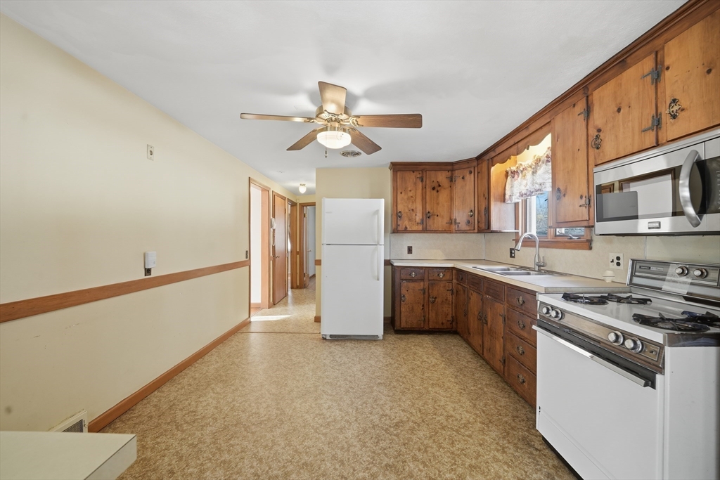 80 Jean Drive Springfield, MA 01104 - Photo 9 of 42 a kitchen with stainless steel appliances a refrigerator a stove a sink dishwasher and a oven with wooden floor
