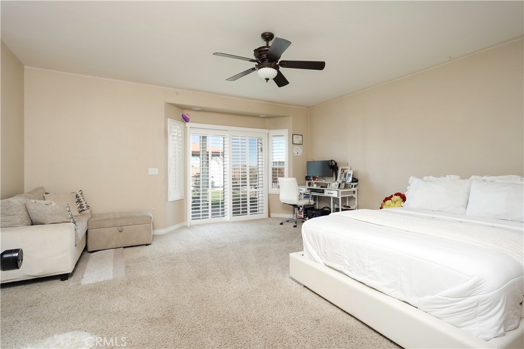 42561 25th Street West Lancaster, CA 93536 - Photo 15 of 41 a spacious bedroom with a bed and a couch