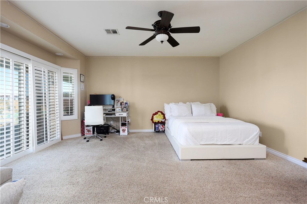 42561 25th Street West Lancaster, CA 93536 - Photo 16 of 41 a bedroom with a bed a couch and a window