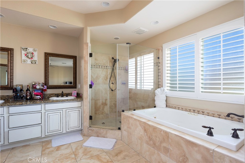 42561 25th Street West Lancaster, CA 93536 - Photo 18 of 41 a bathroom with a tub sink mirror and a shower