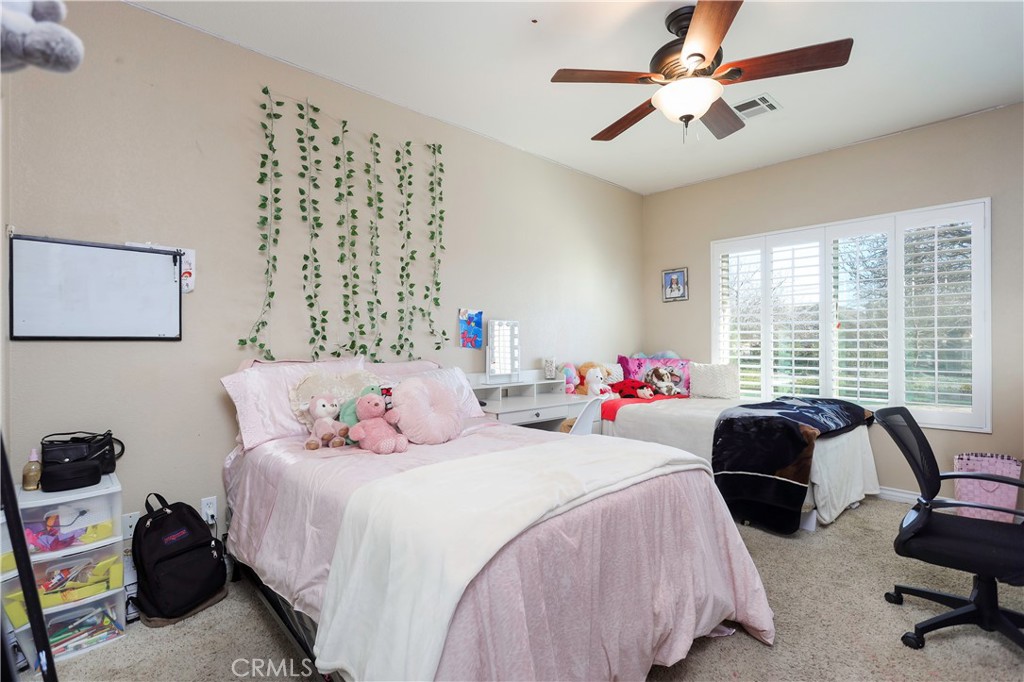 42561 25th Street West Lancaster, CA 93536 - Photo 22 of 41 a bedroom with bed and a large window