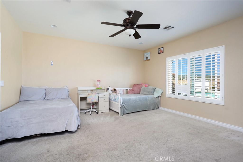 42561 25th Street West Lancaster, CA 93536 - Photo 24 of 41 a living room with furniture and a ceiling fan