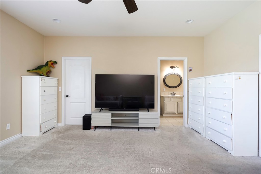 42561 25th Street West Lancaster, CA 93536 - Photo 26 of 41 a living room with furniture and a flat screen tv