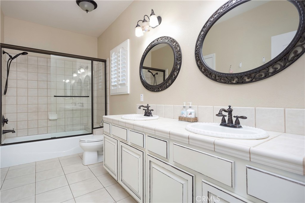 42561 25th Street West Lancaster, CA 93536 - Photo 30 of 41 a bathroom with a toilet a sink and a mirror