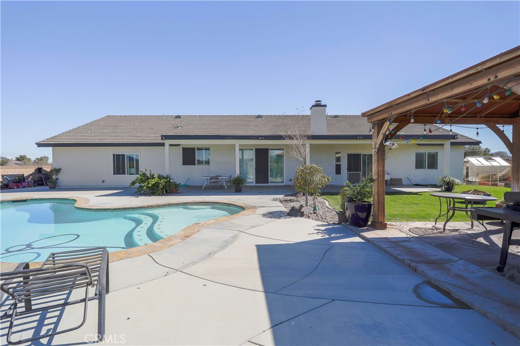 42561 25th Street West Lancaster, CA 93536 - Photo 31 of 41 a view of a house with swimming pool and sitting area