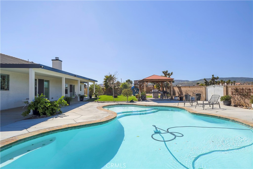 42561 25th Street West Lancaster, CA 93536 - Photo 32 of 41 a view of a house with swimming pool and sitting area