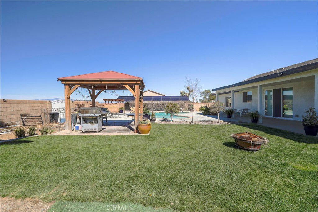 42561 25th Street West Lancaster, CA 93536 - Photo 35 of 41 a view of a house with backyard porch and furniture