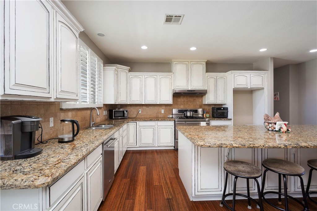 42561 25th Street West Lancaster, CA 93536 - Photo 10 of 41 a large kitchen with granite countertop lots of counter space and stainless steel appliances
