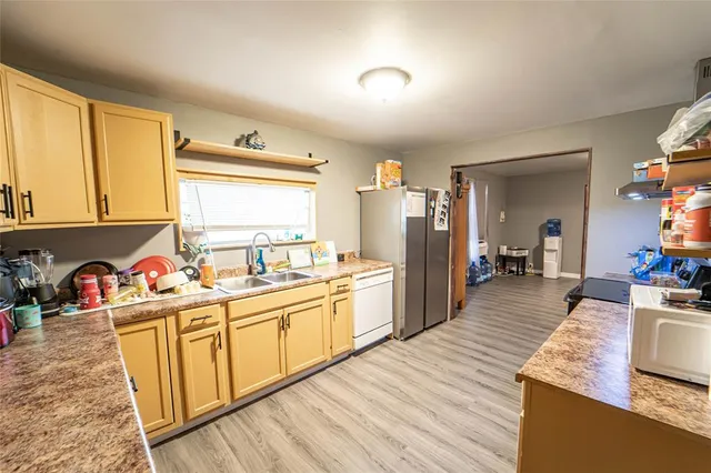 a kitchen with a sink stove and wooden cabinets