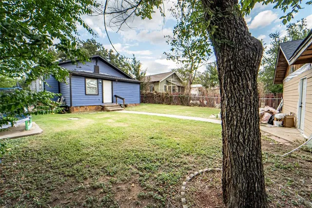 a view of a house with a yard and sitting area