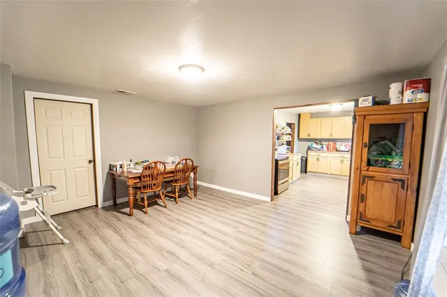 a dining room with furniture and wooden floor