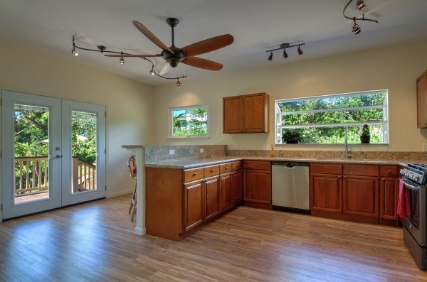 4386 Upa Road, Unit 2 Koloa, HI 96756 - Photo 4 of 25 a kitchen with stainless steel appliances granite countertop wooden floors and sink