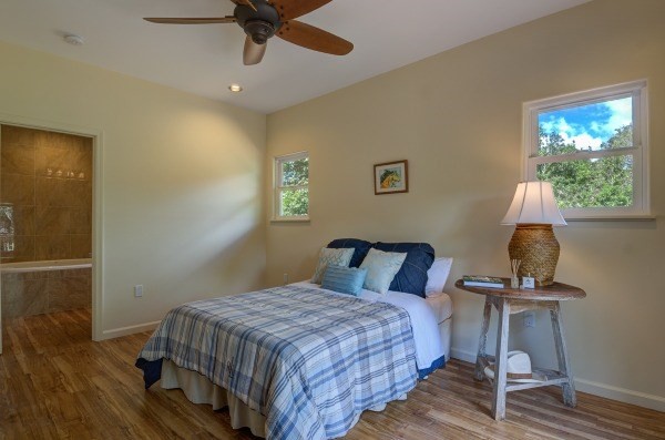 4386 Upa Road, Unit 2 Koloa, HI 96756 - Photo 10 of 25 a bedroom with a bed and wooden floor