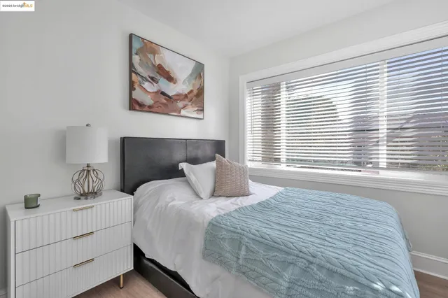 a bedroom with a large bed and a window