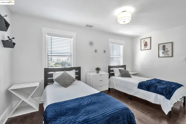 a bedroom with two beds and a table