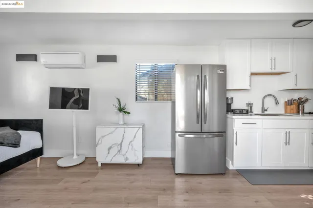 a kitchen with a refrigerator and cabinets