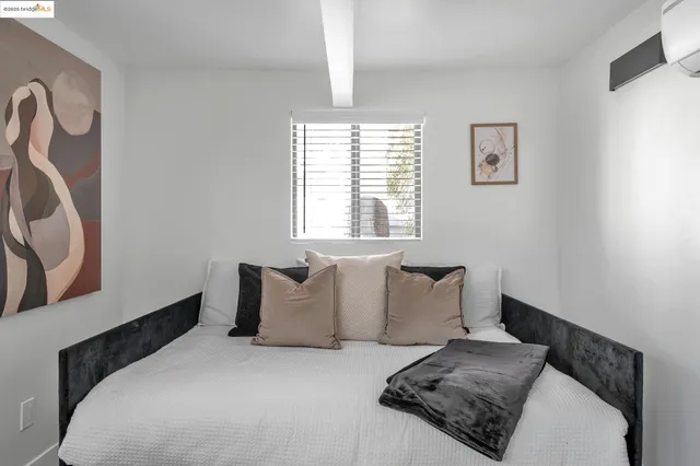 a bedroom with a bed and a window