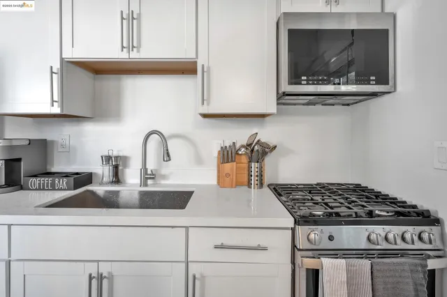 a white stove top oven sitting inside of a kitchen