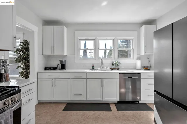 a kitchen with white cabinets and a stove