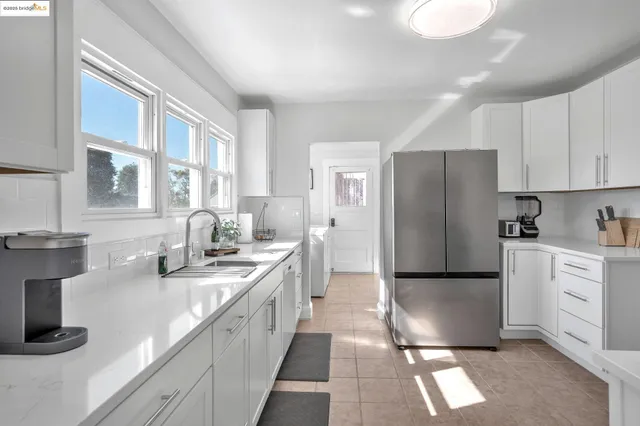 a kitchen with stainless steel appliances granite countertop a refrigerator a sink a stove a microwave and island