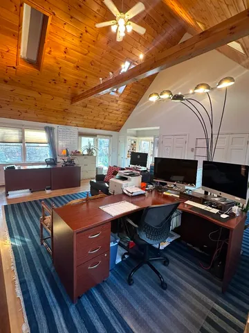 a room with furniture pool table and a flat screen tv