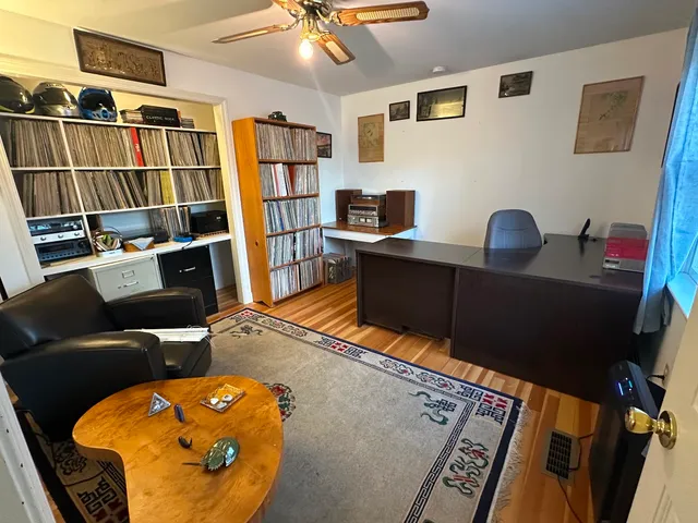 a bed sitting in a bedroom next to a cabinet