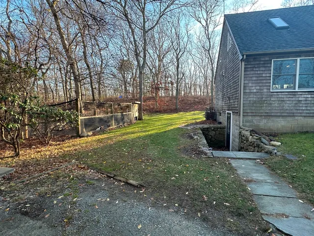 a view of a backyard with large trees