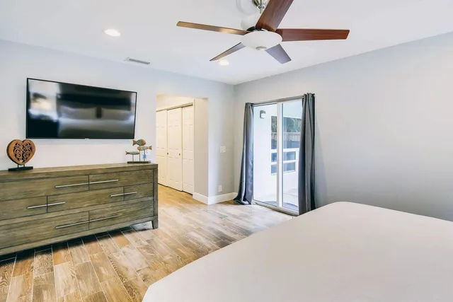 a bedroom with a bed and a flat screen tv