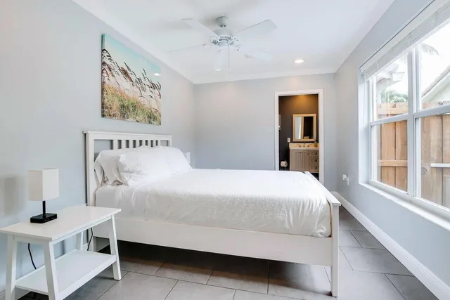 a bedroom with a bed and a table in it with window