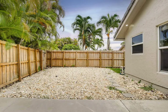 a view of house with backyard and garden