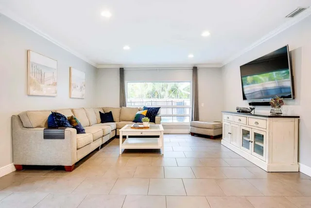 a living room with furniture and a flat screen tv