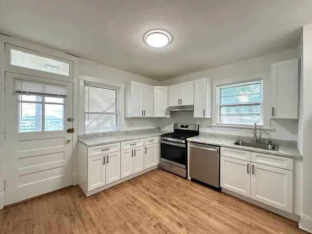 a kitchen with stainless steel appliances granite countertop a sink and cabinets