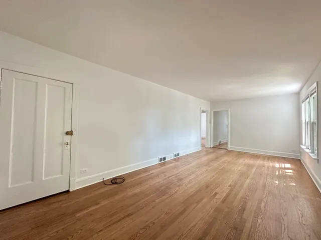 a view of an empty room and wooden floor