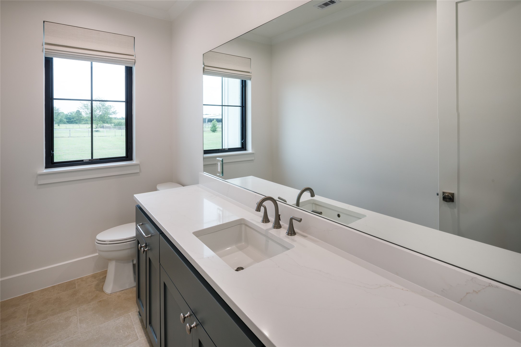 24118 Margerstadt Road Hockley, TX 77447 - Photo 27 of 46 Oversized vanities, generous storage, and durable finishes give the secondary bathrooms a clean and practical layout for everyday use. Thoughtful proportions and neutral materials keep the spaces feeling consistent with the overall design of the home.