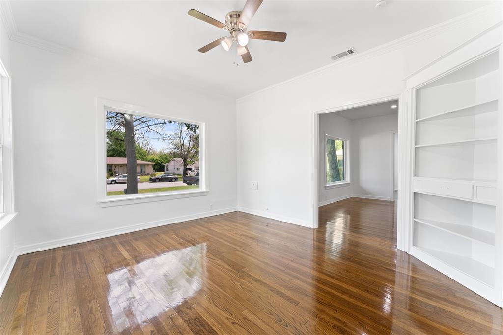 2405 Monroe Street Commerce, TX 75428 - Photo 9 of 31 a view of an empty room with a window and wooden floor