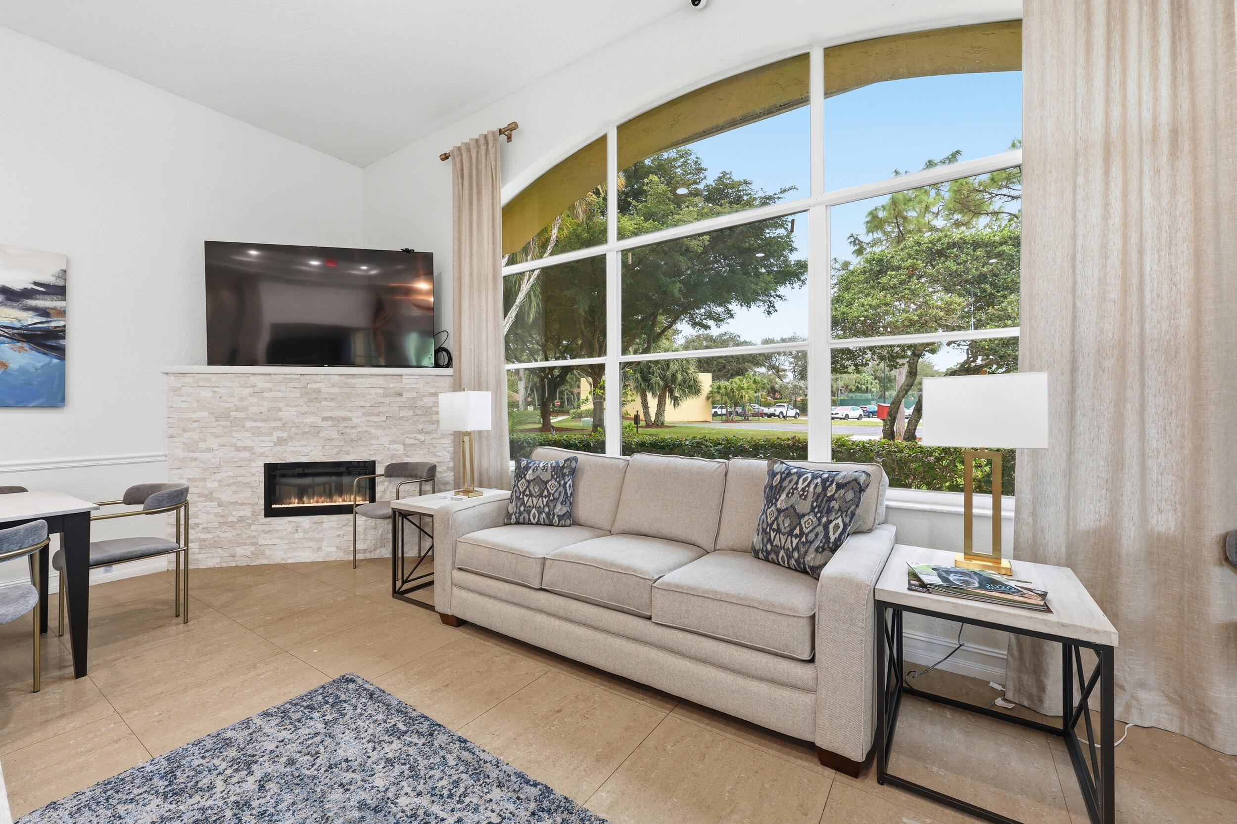 2013 Bonisle Circle Riviera Beach, FL 33418 - Photo 18 of 22 a living room with furniture a large window and a fireplace