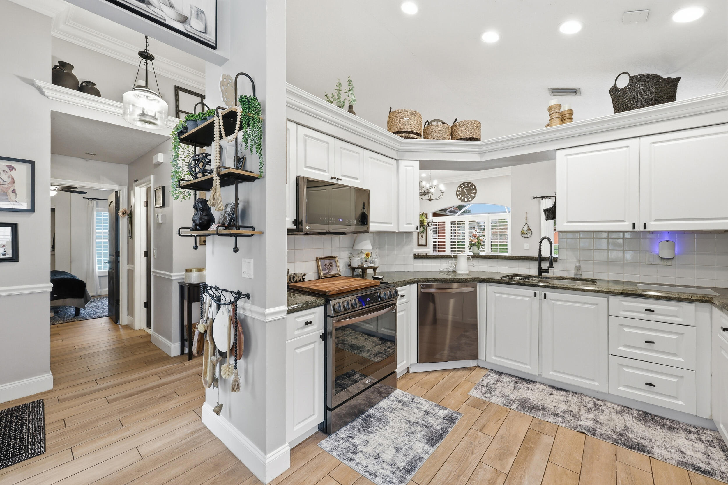 2013 Bonisle Circle Riviera Beach, FL 33418 - Photo 3 of 22 a kitchen with stainless steel appliances granite countertop a sink and cabinets