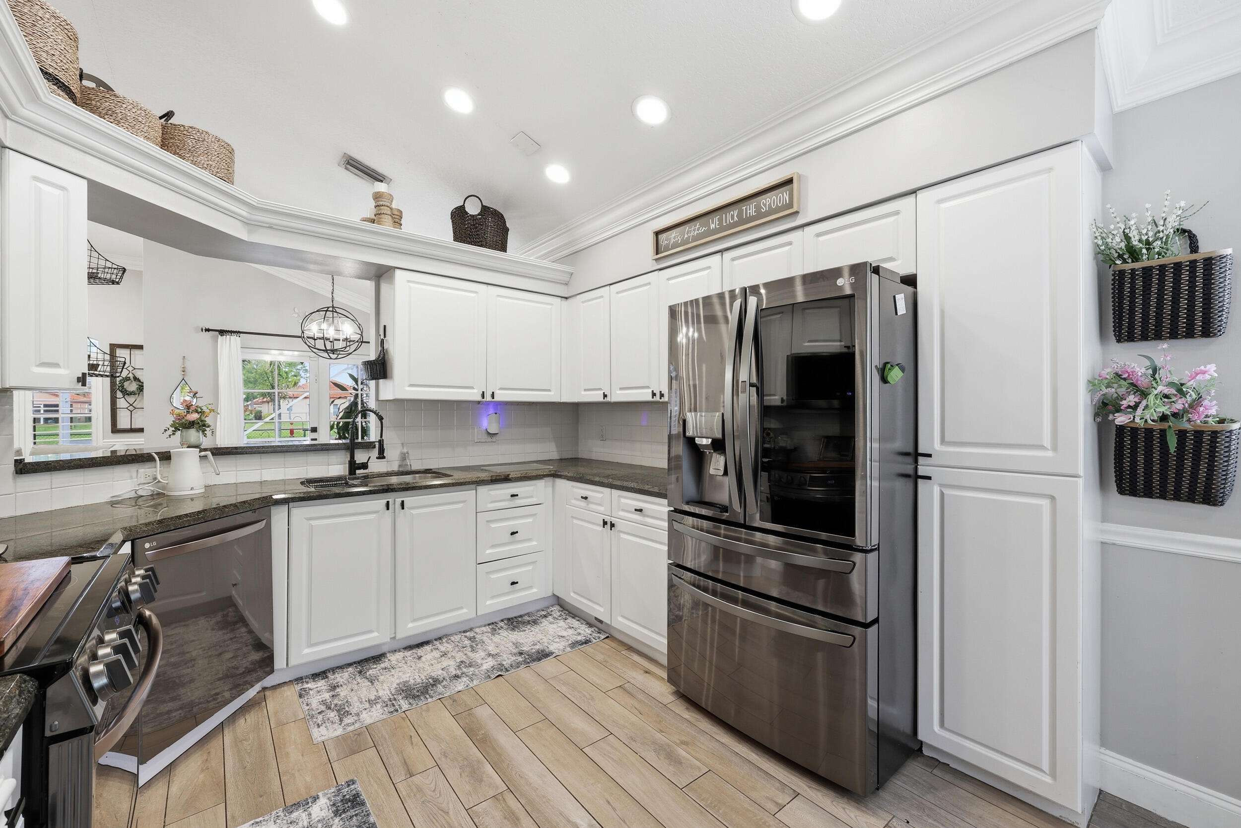 2013 Bonisle Circle Riviera Beach, FL 33418 - Photo 4 of 22 a kitchen with granite countertop stainless steel appliances and wooden cabinets