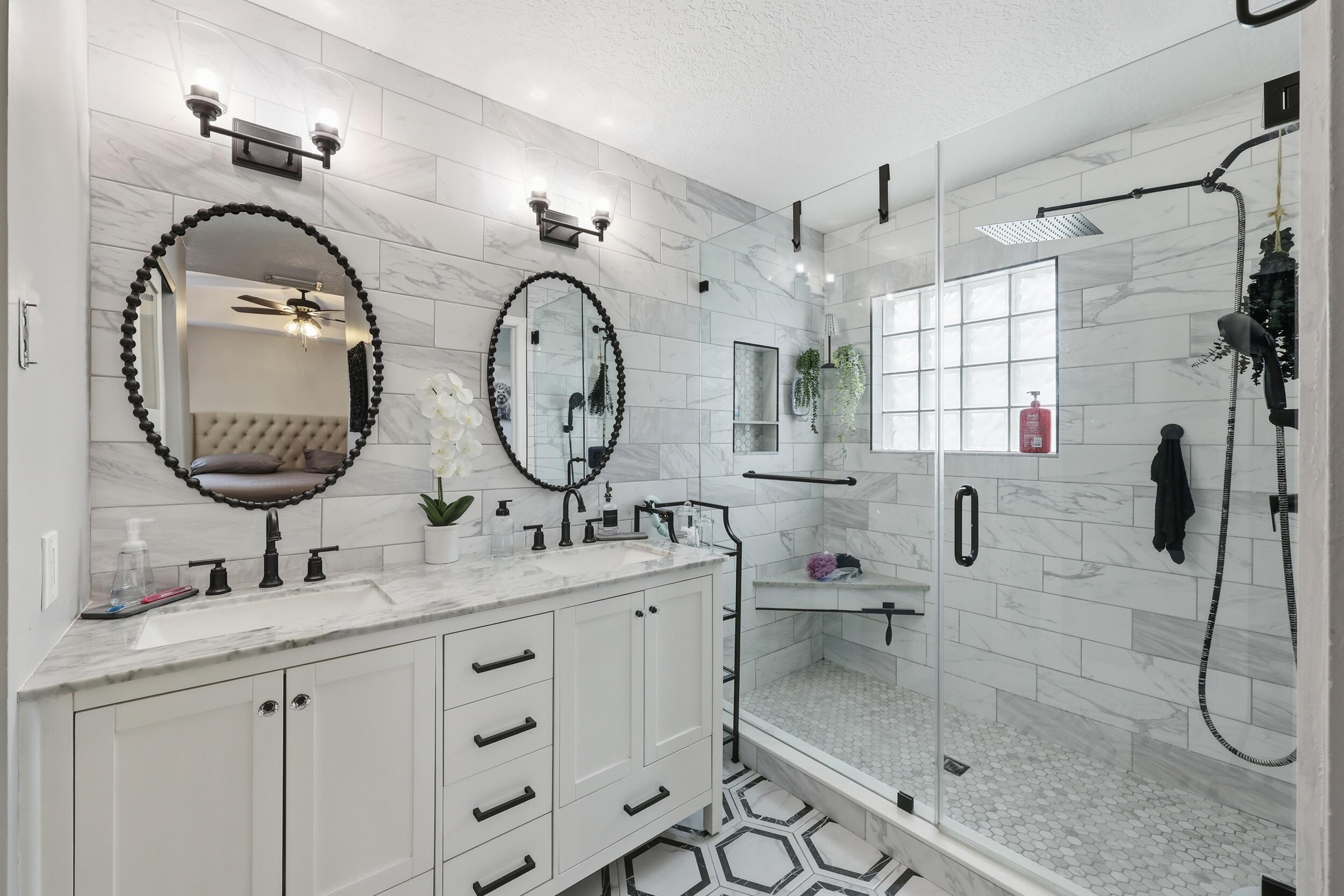 2013 Bonisle Circle Riviera Beach, FL 33418 - Photo 8 of 22 a bathroom with a double vanity sink mirror and shower