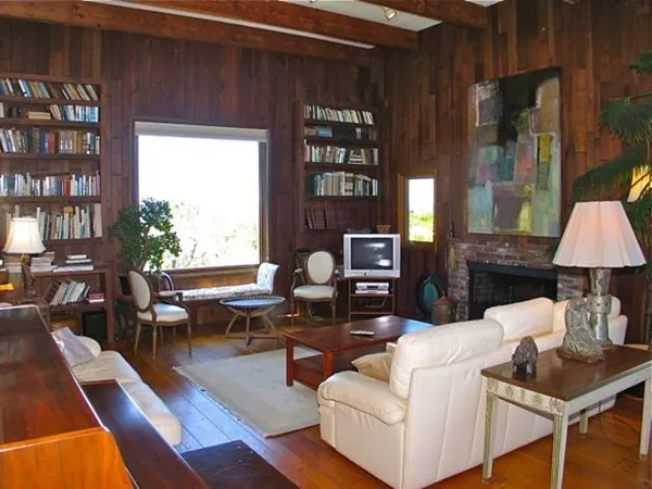 a living room with furniture a lamp and a window