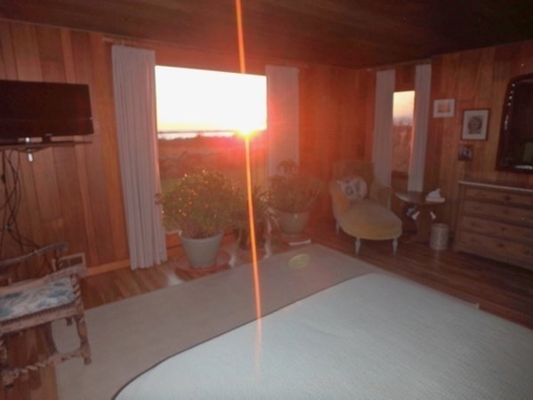 19 Lake Road Chilmark, MA 02535 - Photo 16 of 32 a living room with furniture a flat screen tv and a fireplace