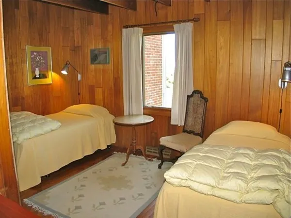 a bedroom with a bed and a table