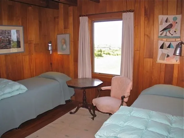 a bedroom with a bed and a table