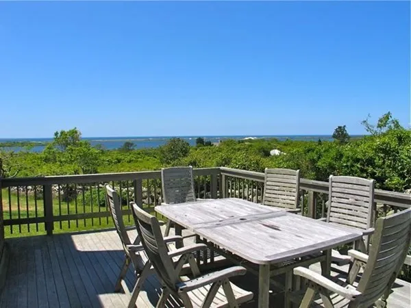 a view of a patio with wooden floor and city view