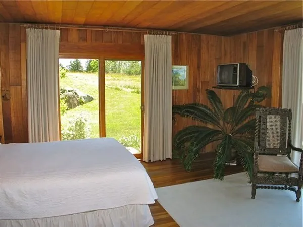 a bedroom with a bed and large window