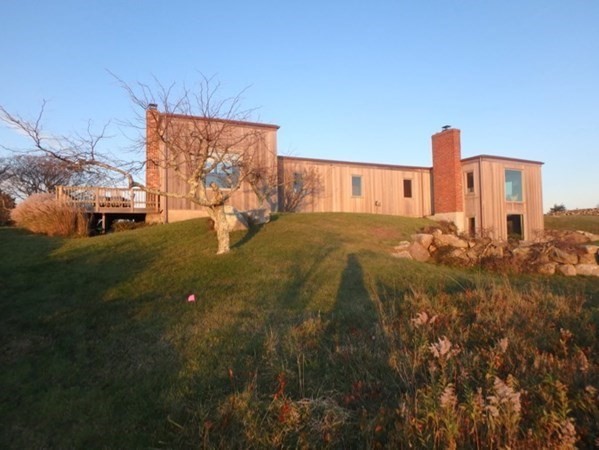 19 Lake Road Chilmark, MA 02535 - Photo 29 of 32 a backyard of a house with table and chairs
